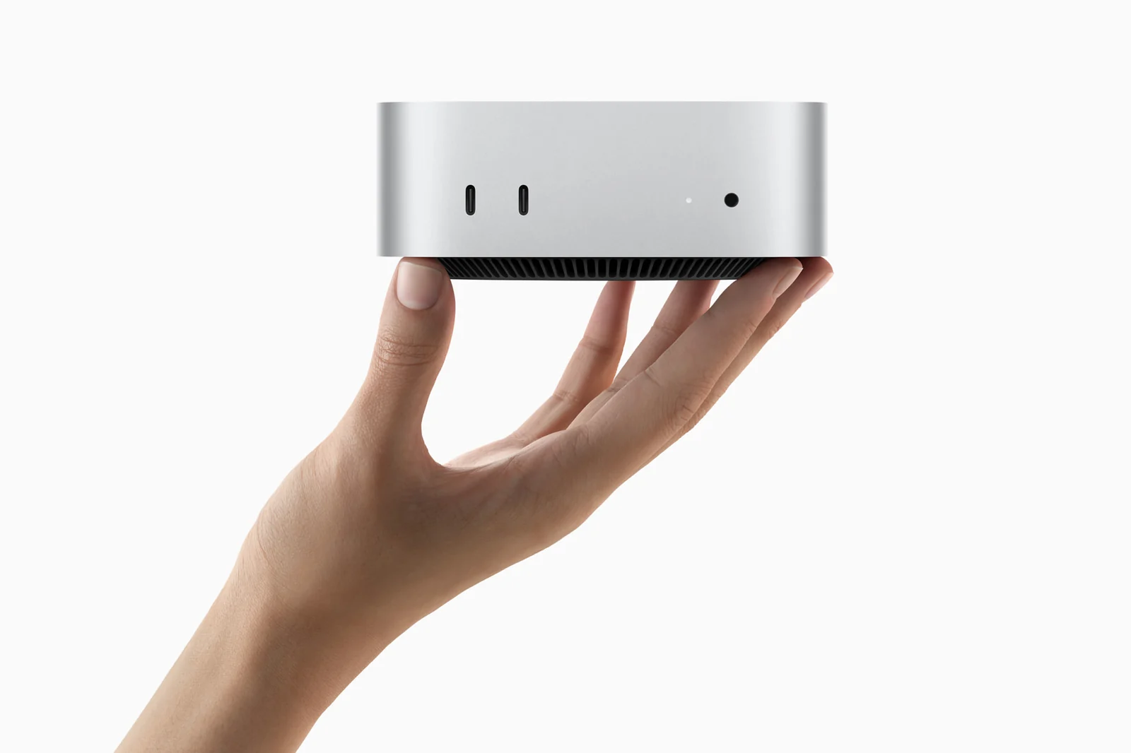 Apple Mac mini (2024), compact design shown in hand